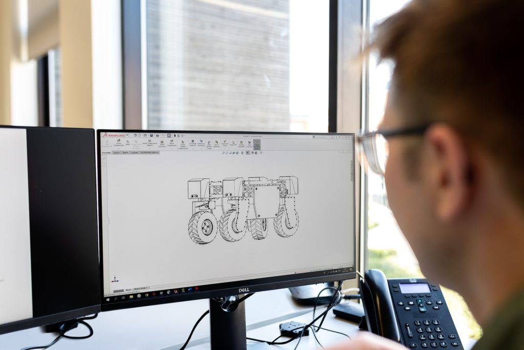 An engineer working on a tech project on a computer